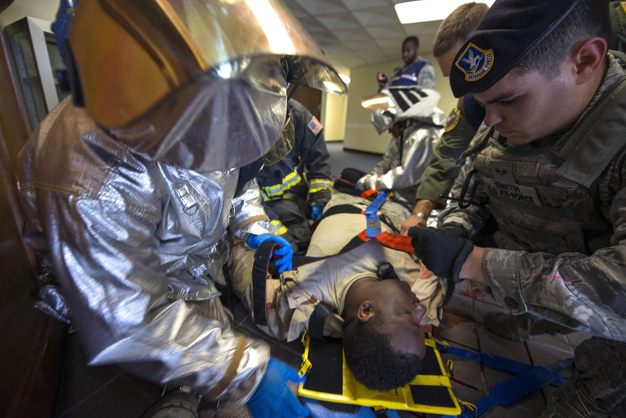 U.S. Air Force emergency responders treat a simulated casualty, at Kadena Air Base, Japan, during an active shooter exercise May 4, 2016. The scenario acted as a training tool for participants, giving them insight into a potential real-world active shooter situation in the future. (U.S. Air Force photo by Staff Sgt. Maeson L. Elleman/Released)