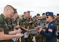 Capt. Sara Harper, U.S. Air Force Air Demonstration Squadron public affairs officer, Nellis Air Force Base, Nev., signs autographs for cadets from the Louisiana Wing of the Civil Air Patrol during the 2016 Defenders of Liberty Airshow at Barksdale Air Force Base, La., May 1. Harper, or Thunderbird 12, is responsible for the team’s marketing, recruiting and publicity programs. (U.S. Air Force photo/Staff Sgt. Joseph A. Pagán Jr.)