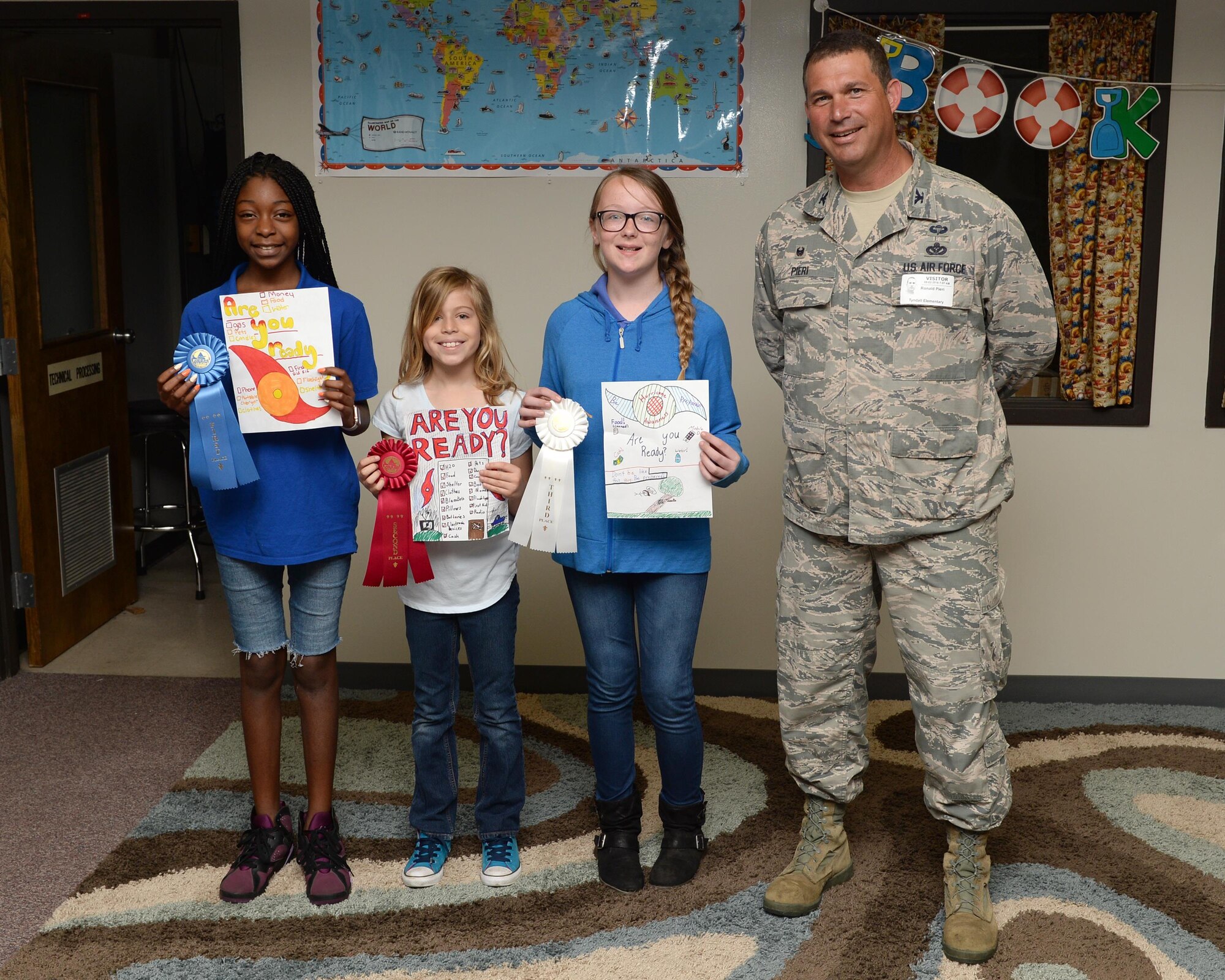 Colonel Ronald Pieri, 325th Mission Support Group commander, stands with the winners of the Hurricane Preparedness Poster Contest at Tyndall Elementary School, May 2. The 325th Civil Engineering Squadron Emergency Management and Readiness Flight organizes the contest every year in order to teach children the importance of preparing for disasters. This program is part of the Air Force “Be Ready Program.” The goal of the program is to spread emergency readiness and awareness. (U.S. Air Force photo by Airman 1st Class Cody R. Miller/Released) 