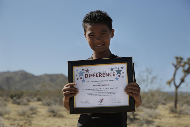 Keandre Jackson, son of Sgt. Dana Jackson, landing support specialist, Combat Logistics Battalion 7, received two awards at the Mojave Desert Land Trust Earth Day Restoration of the Gateway Parcel in Joshua Tree, Calif., April 23, 2016. He received the Outstanding Military Child Award Award and recognition from the Armed Services YMCA Military Child. (Official Marine Corps photo by Pfc. Dave Flores/Released)