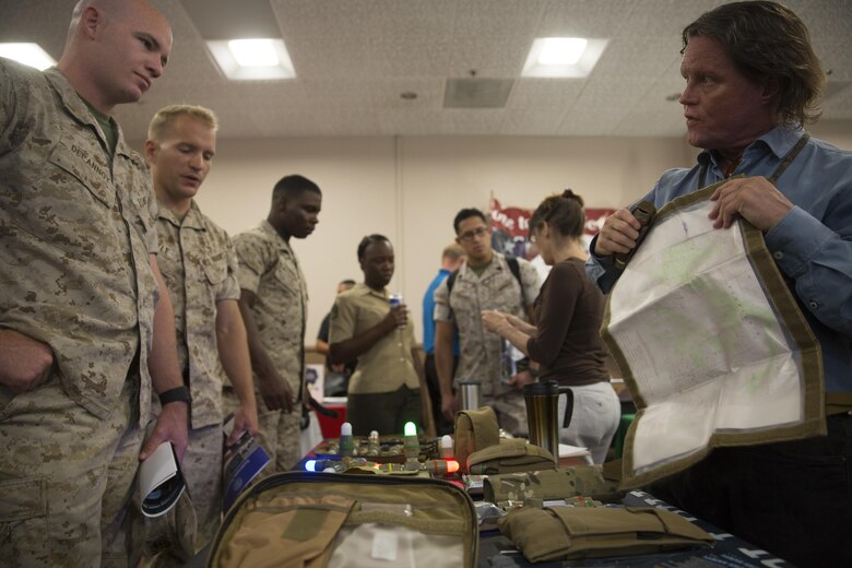 Greg Kennedy, Tactical Lighting Solutions representative, shows off the Lazer Brite Tactical Pouch to Marines during the Combat Center’s Sustainability Expo at the Frontline Restaurant April 26, 2016. (Official Marine Corps photo by Cpl. Connor Hancock/Released)
