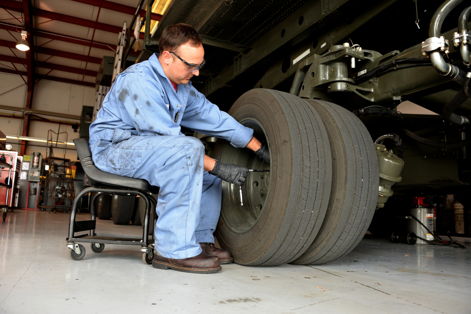 Cory Bellmore, 60th Logistics Readiness Squadron heavy vehicle mechanic, checks the level of the hubs on a Tunner 60K aircraft loader April 26, 2016, at Travis Air Force Base, California. Travis Air Force Base has a total of 17 Tunner 60K aircraft loaders supporting aerial port squadron operations, the largest 60K loader fleet in the Air Force. (U.S. Air Force photo by Staff Sgt. Charles Rivezzo)