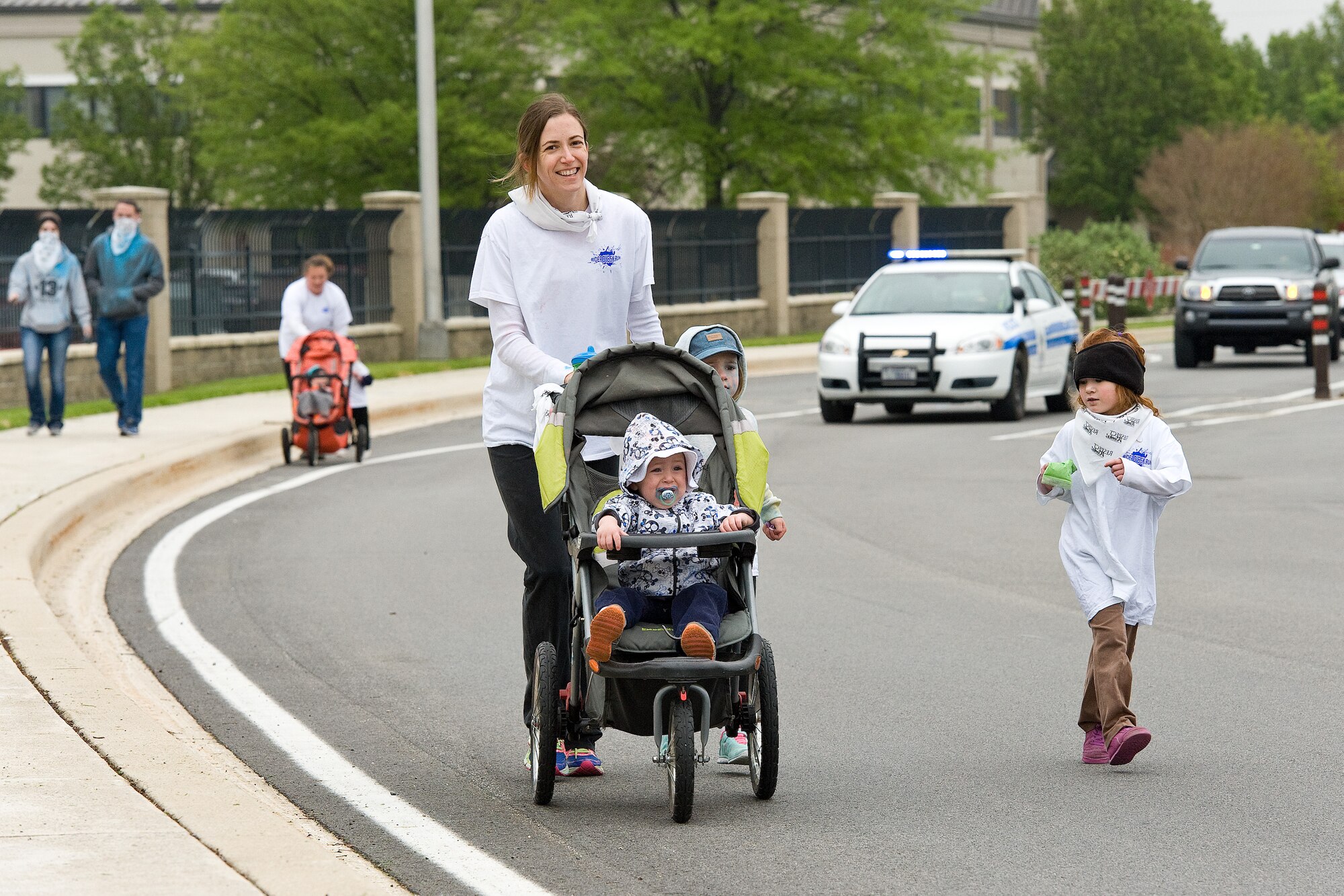 Team Dover 5K Color Run participants of all ages head out of the main gate April 28, 2016, on Dover Air Force Base, Del. The run was one of many events hosted by the Dover AFB Sexual Assault Prevention Response office during Sexual Awareness Month. (U.S. Air Force photo/Roland Balik)