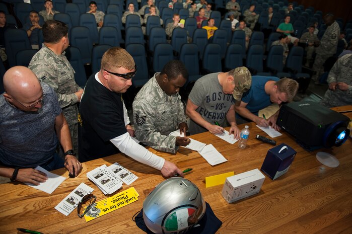 Service members, dependents and civilians sign in during the annual Motorcycle Safety Day, April 29, 2016, at Joint Base Charleston, S.C. The annual briefing is required by AFI 91-207, for all active duty Air Force motorcyclists. (U.S. Air Force photo/Staff Sgt. Jared Trimarchi) 