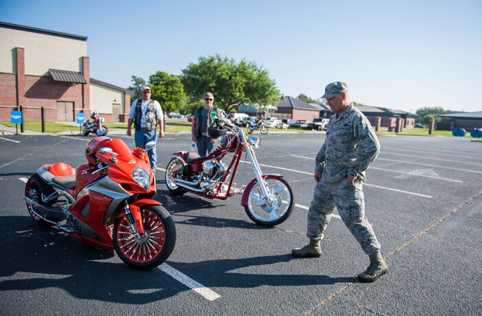 Col. Jimmy Canals, 437th Airlift Wing vice commander, chooses the best custom bike during the annual Motorcycle Safety Day, April 29, 2016, at Joint Base Charleston, S.C. The annual briefing is required by AFI 91-207, for all active duty Air Force motorcyclists. (U.S. Air Force photo/Staff Sgt. Jared Trimarchi) 