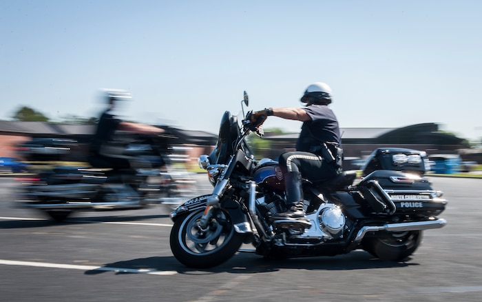 A North Charleston police officer demonstrates his motorcycle skills during the annual Motorcycle Safety Day, April 29, 2016, at Joint Base Charleston, S.C. The annual briefing is required by AFI 91-207, for all active duty Air Force motorcyclists. More than 200 service members, dependents and civilians attended. (U.S. Air Force photo/Staff Sgt. Jared Trimarchi) 