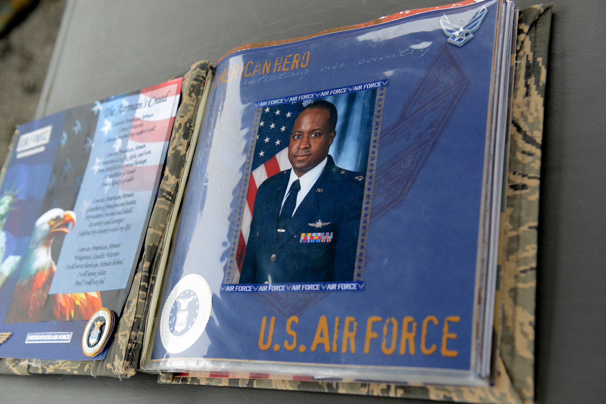 Members of the 83rd Network Operations Squadron put together a memorial book for the family of Maj. Charles A. Ransom, a cyberspace Airman assigned to the 83rd Network Operations Squadron, Langley Air Force Base, Va. The book was displayed for Airmen to see before the annual Major Ransom Memorial 5K run April 28, 2016. (U.S. Air Force photo by Staff Sgt. Teresa J. Cleveland)