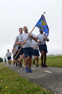 A formation of nine U.S. Air Force Airmen lead the Annual Major Ransom Memorial 5K run at Langley Air Force Base, Va., April 28, 2016. The memorial run is held annually in remembrance of Maj. Charles Ransom and the NATC-A NINE, nine American killed at the Kabul airport in 2011. (U.S. Air Force photo by Staff Sgt. Teresa J. Cleveland)