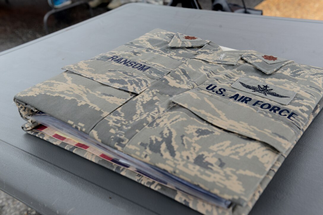 Members of the 83rd Network Operations Squadron put together a scrapbook for the family of Maj. Charles A. Ransom, a cyberspace Airman assigned to the 83rd Network Operations Squadron, Langley Air Force Base, Va. Ransom was a captain who had been selected for the rank of major when he died April 27, 2011, at the Kabul International Airport in Afghanistan. (U.S. Air Force photo by Staff Sgt. Teresa J. Cleveland)