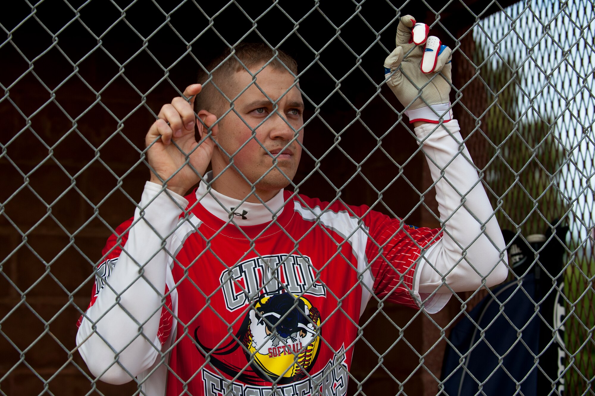 U.S. Air Force Staff Sgt. Nathan Hupp, Heating, Ventilation and Air Conditioning technician with the 633rd Civil Engineering Squadron, watches a softball game at the 2nd Annual Kings of the Bay Softball Tournament at Langley Air Force Base, Va., April 30, 2016. The tournament was created to bring together avid softball players to build morale and raise funds for the 30th Intelligence Squadron. (U.S. Air Force photo by Airman 1st Class Kaylee Dubois).
