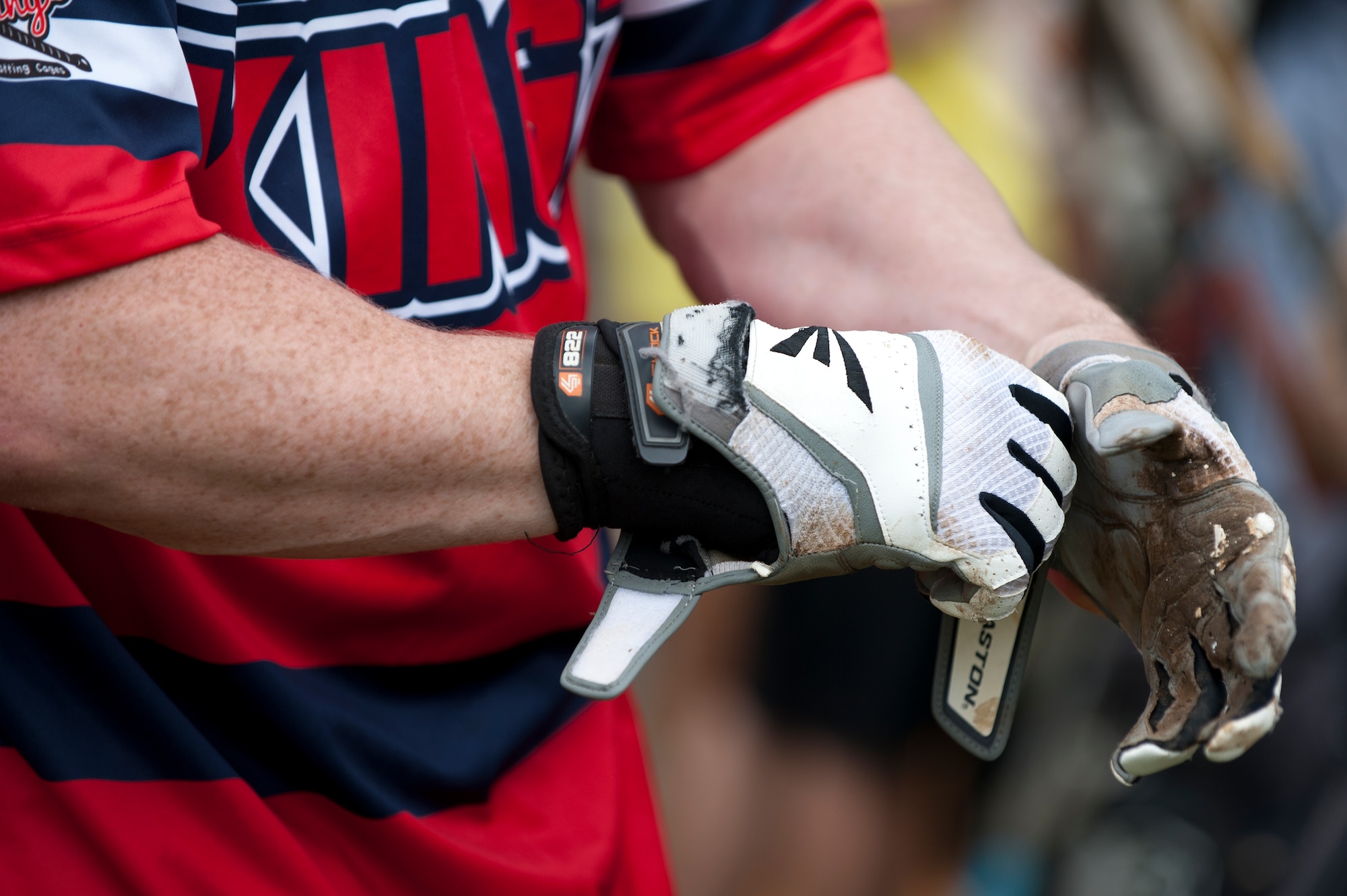 A member of the Swing Kingz softball team straps on batting gloves before batting at the 2nd Annual Kings of the Bay Softball Tournament at Langley Air Force Base, Va., April 30, 2016. The multi-branch tournament hosted seven softball teams from all over the peninsula. (U.S. Air Force photo by Airman 1st Class Kaylee Dubois)