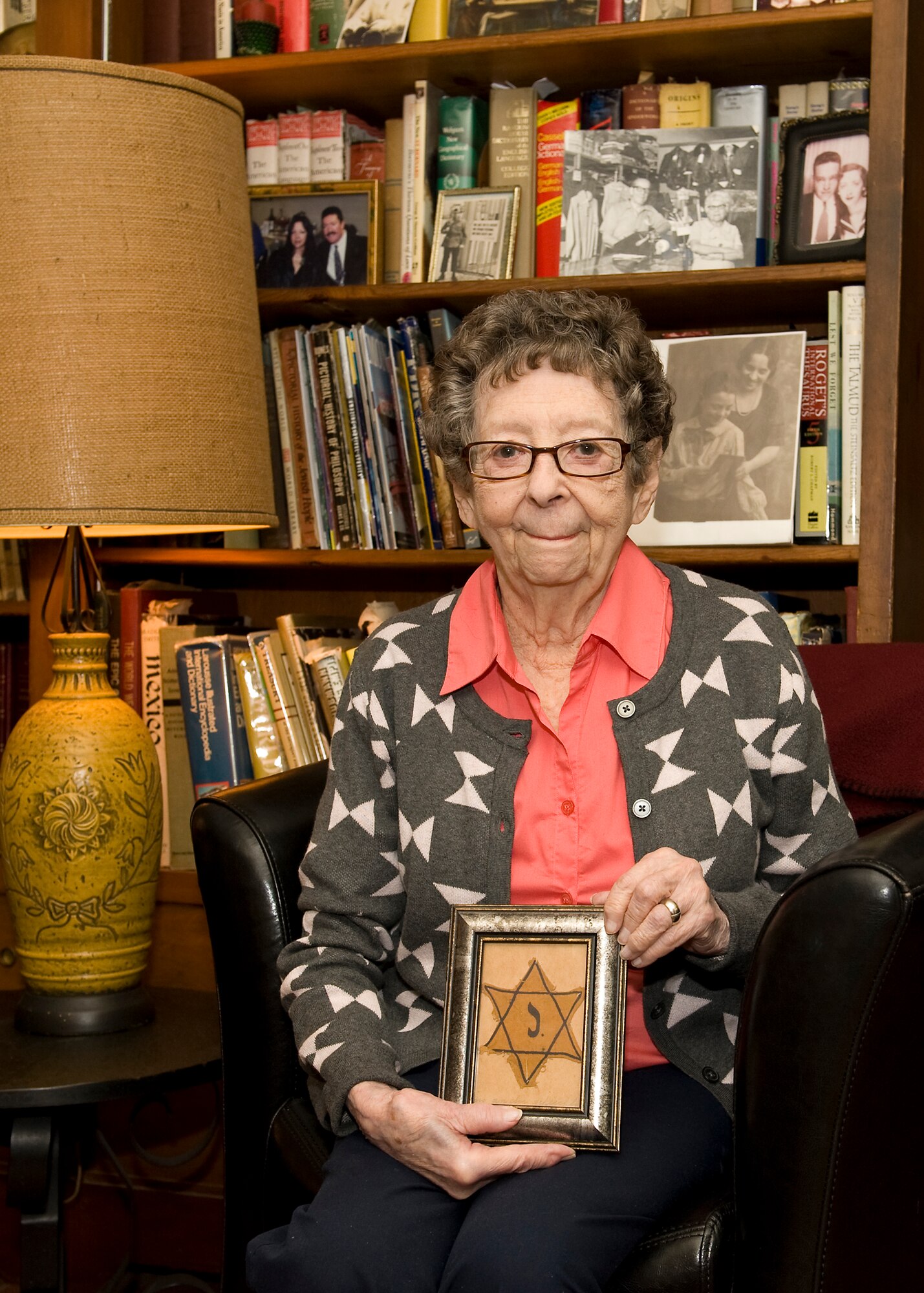 Kitty Saks, a Holocaust survivor, displays the star she wore during the Holocaust to distinguish her Jewish faith in her home in Norfolk, Va., April 29, 2016. Saks was one of many children that survived persecution by hiding with their parents, in convents, orphanages or any place that provided safety from Nazi forces. (U.S. Air Force photo by Airman 1st Class Kaylee Dubois)