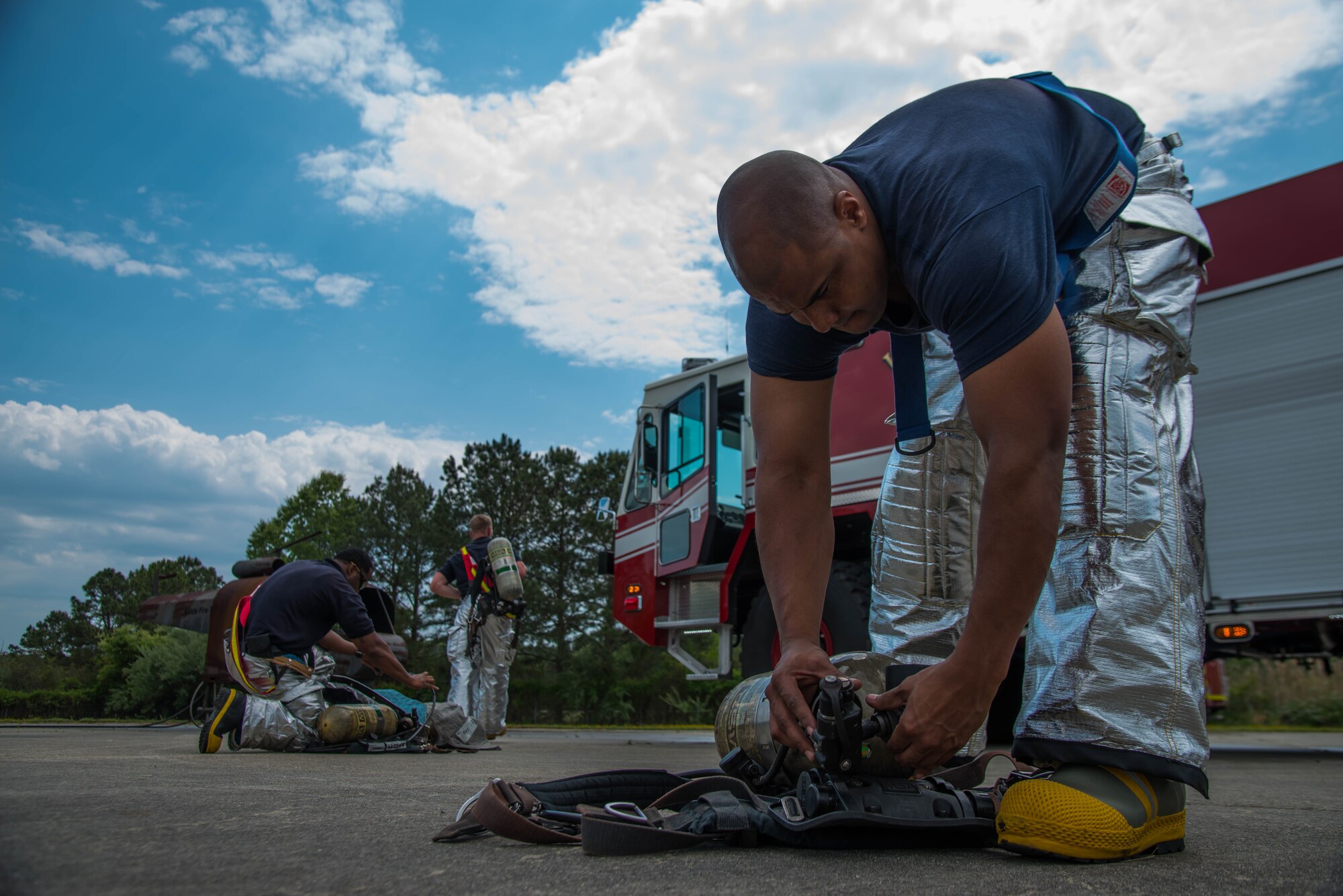 Fort Eustis fire department fire fighters check and reassemble their gear after the aircraft live-fire exercise at Fort Eustis, Va., April 27, 2016. The fire fighters use a “Kidde” propane fueled trainer. (U.S. Air Force photo by Staff Sgt. J.D. Strong II)