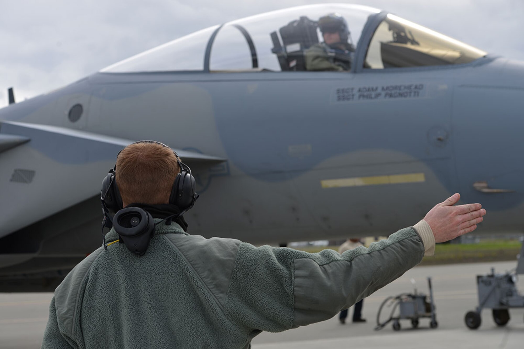 Air Force Staff Sgt. Austin Hamilton, 96th Aircraft Maintenance Squadron F-15 crew chief, from Eglin Air Force Base, Fla., signals an F-15 Eagle pilot while preparing departure on the Joint Base Elmendorf-Richardson flightline, May 3, 2016. Hamilton is deployed to JBER as part of Red Flag-Alaska, a Pacific Air Forces commander-directed field training exercises for U.S. and international forces, providing combined offensive counter-air, interdiction, close air support and large force employment training in a simulated combat environment. (U.S. Air Force photo by Airman 1st Class Javier Alvarez)