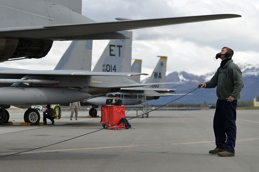 Air Force Staff Sgt. Austin Hamilton, an F-15 crew chief with the 96th Aircraft Maintenance Squadron, Eglin Air Force Base, Fla., performs a preliminary flight check, at the Joint Base Elmendorf-Richardson flightline, May 3, 2016. Hamilton is deployed to JBER as part of Red Flag-Alaska, a Pacific Air Forces commander-directed field training exercises for U.S. and international forces, providing combined offensive counter-air, interdiction, close air support and large force employment training in a simulated combat environment. (U.S. Air Force photo by Airman 1st Class Javier Alvarez)