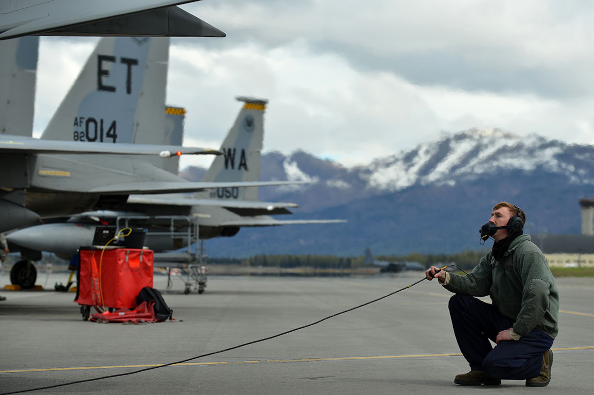 Air Force Staff Sgt. Austin Hamilton, an  F-15 Eagle crew chief with the 96th Aircraft Maintenance Squadron, Eglin Air Force Base, Fla., performs routine checks while his pilot prepares to taxi on Joint Base Elmendorf-Richardson's flightline May 3 during RED FLAG-Alaska 16-1. RF-Alaska is a Pacific Air Forces commander-directed field training exercise for U.S. and international forces, which provides joint offensive counter-air, interdiction, close air support, and large-force employment training in a simulated combat environment. (U.S. Air Force photo by Airman 1st Class Kyle Johnson)