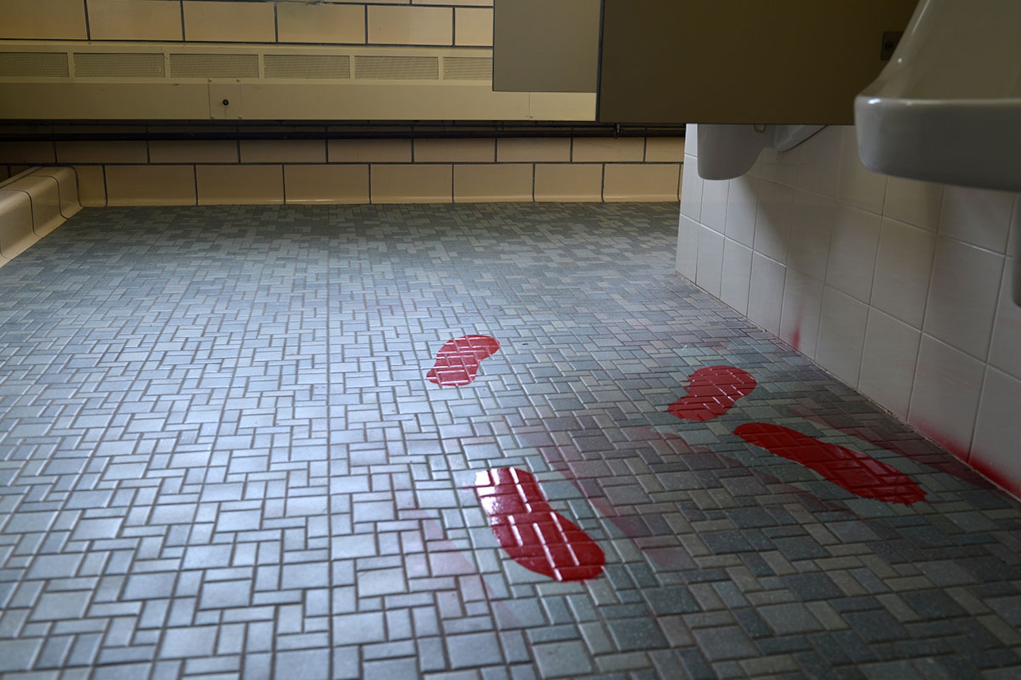 Male personnel stand on the red footprints when producing a urine sample to ensure an accurate and tamper-free sample is provided. The Drug Demand Reduction Program on Joint Base Elmendorf-Richardson is constantly in service, ensuring service members remain drug-free. (U.S. Air force photo by Airman 1st Class Javier Alvarez)