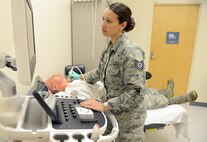Technical Sgt. Christina Williamson Haupt, 78th Medical Group diagnostic imaging NCOIC, takes an ultrasound for Technical Sgt. Christopher Pundsack at the medical clinic. (U.S. Air Force photo by Tommie Horton)