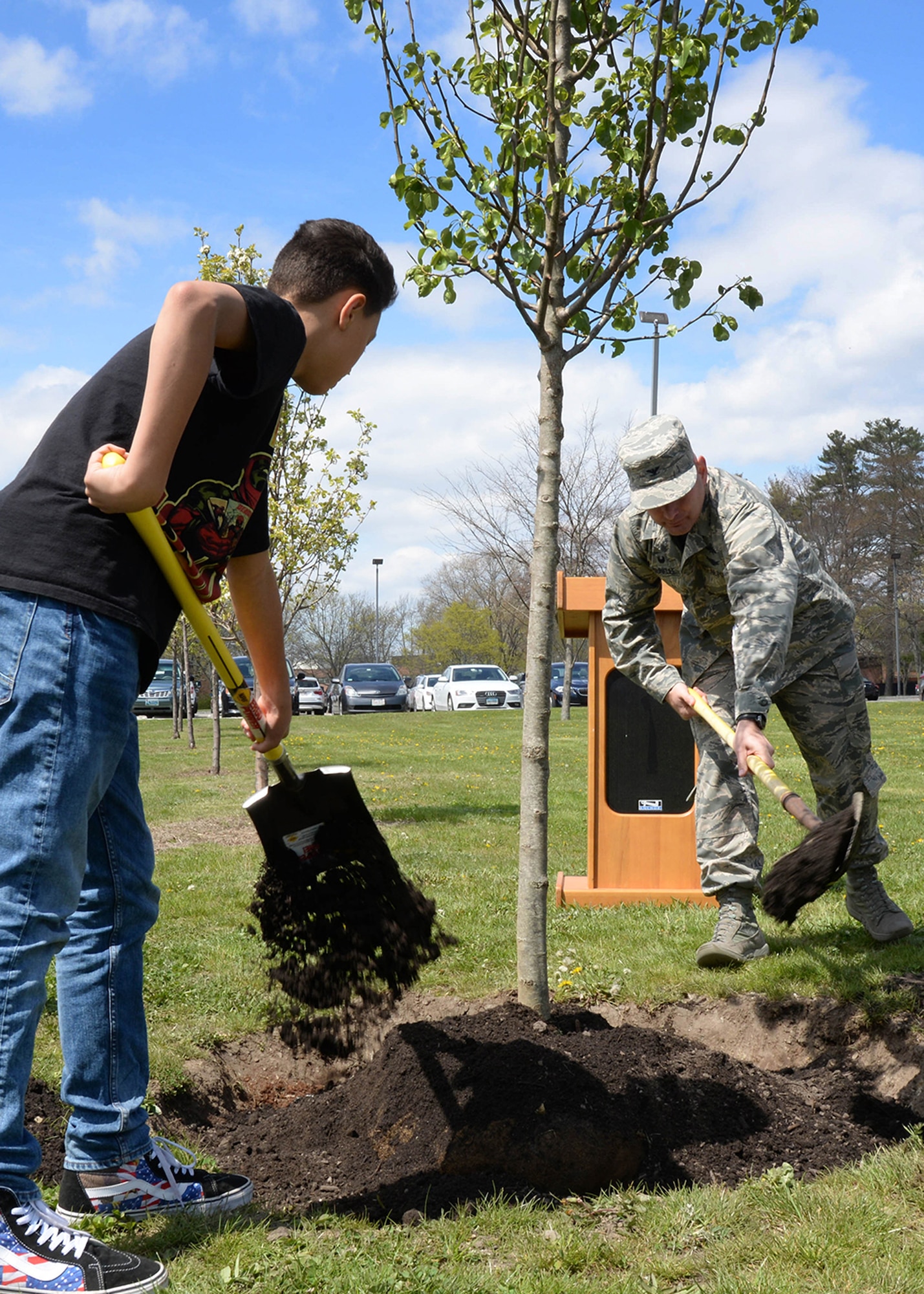 Col. David Dunklee, 66th Air Base Group commander, and JJ Fullerton, a Hanscom Middle School seventh grader, plant a tree along Eglin Street on base April 29. Hanscom Air Force Base, Mass., was recently selected as a Tree City USA town for the 29th consecutive year. The tree planting ceremony was just one of several efforts base personnel accomplished to achieve Tree City USA status. (U.S. Air Force photo by Linda LaBonte Britt )