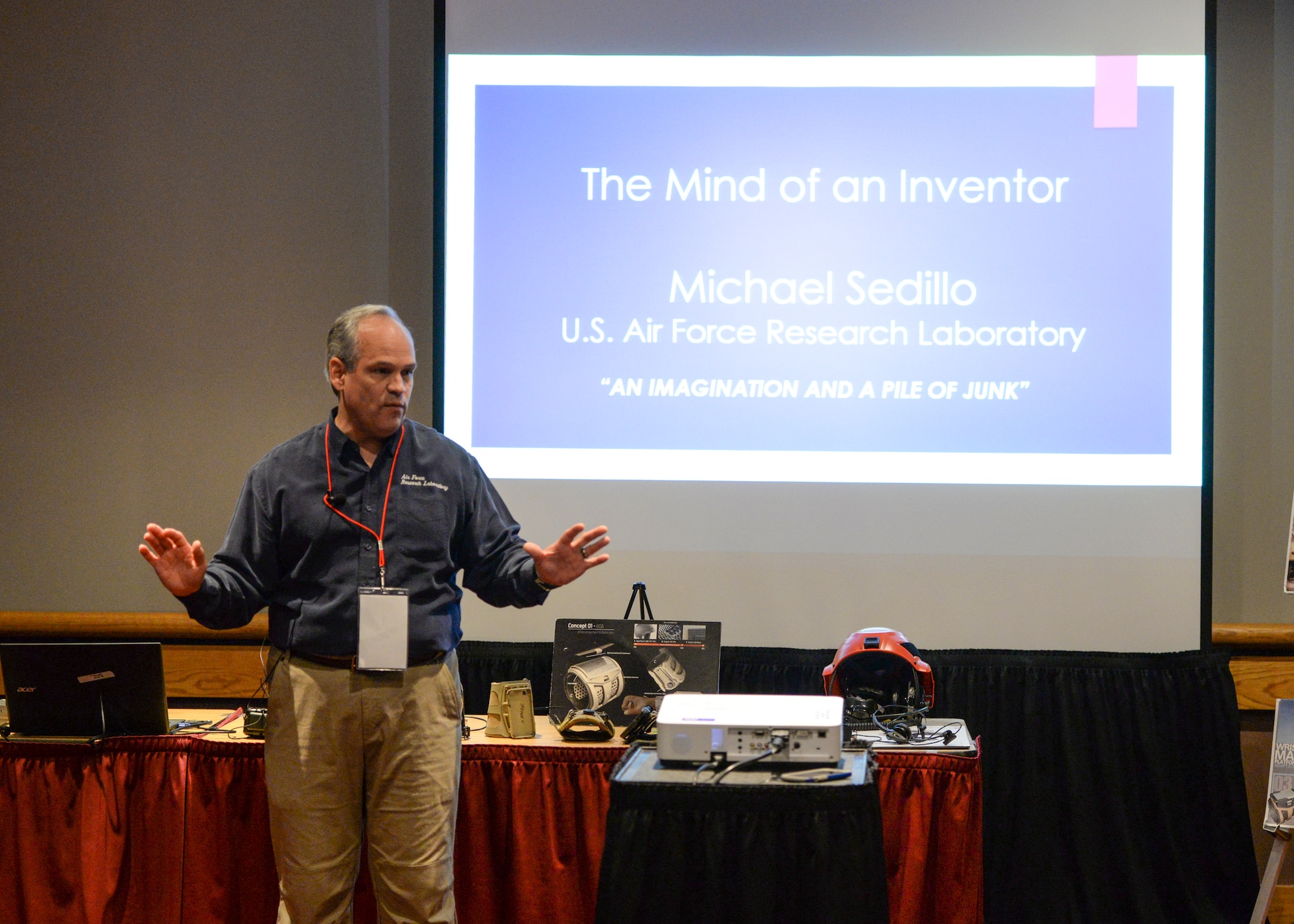 Michael Sedillo, a program analyst with the Air Force Research Laboratory Battlefield Air Targeted Man Aided Knowledge Program, delivers a speech about inventing wearable technology being researched and developed to a room of more than 40 students during the 54th National Junior Science and Humanities Symposium inside the Dayton Convention Center April 28. JSHS is a tri-service, U.S. Army, Navy and Air Force, program that encourages high school students to conduct original research in the fields of science, technology, engineers and mathematics (STEM). (U.S. Air Force photo/Wesley Farnsworth)