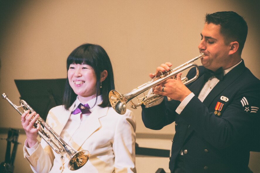 Shizuna Ishizu, the Fussa Wind Ensemble, and Senior Airman David Wuchter, the Air Force Band of the Pacific-Asia, play trumpets during the 7th annual Fussa-Yokota Friendship Concert at Fussa City Hall, Tokyo, Japan, May 1, 2016. The Fussa-Yokota Goodwill Exchange Club hosted the event to strengthen the relationship between the U.S. and Japan through music. (U.S. Air Force photo by Yasuo Osakabe/Released)  