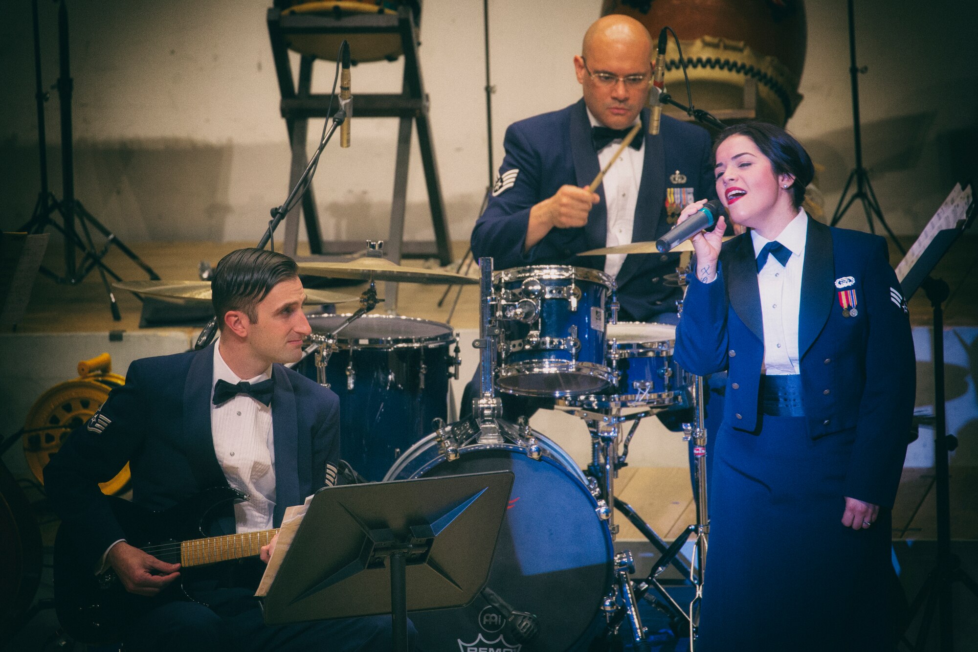 Senior Airman Maritzaida Amador, right, USAF Band of the Pacific-Asia, sings during the 7th annual Fussa-Yokota Friendship Concert at Fussa City Hall, Tokyo, Japan, May 1, 2016. The Fussa-Yokota Goodwill Exchange Club hosted the event to strengthen the relationship between the U.S. and Japan through music. (U.S. Air Force photo by Yasuo Osakabe/Released) 