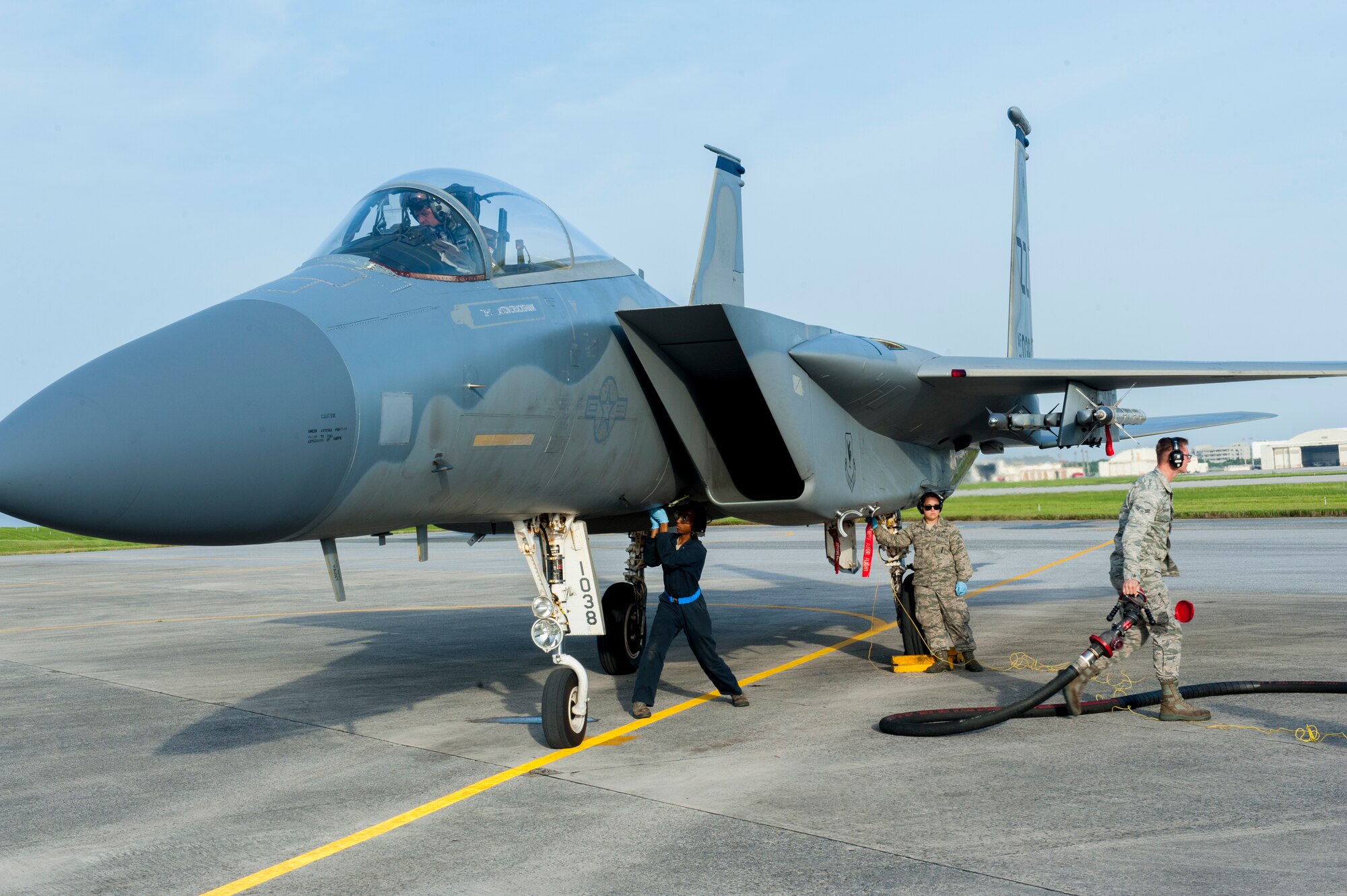 A team consisting of Airmen from the 18th Logistics Readiness Squadron’s petroleum, oil flight and the 44th Aircraft Maintenance Unit refuel an F-15C Eagle during a surge May 4, 2016, at Kadena Air Base, Japan. Hot pits refueling is when an aircraft lands and is refueled while still operational to minimize time on the ground. (U.S. Air Force photo by Airman Zackary A. Henry)