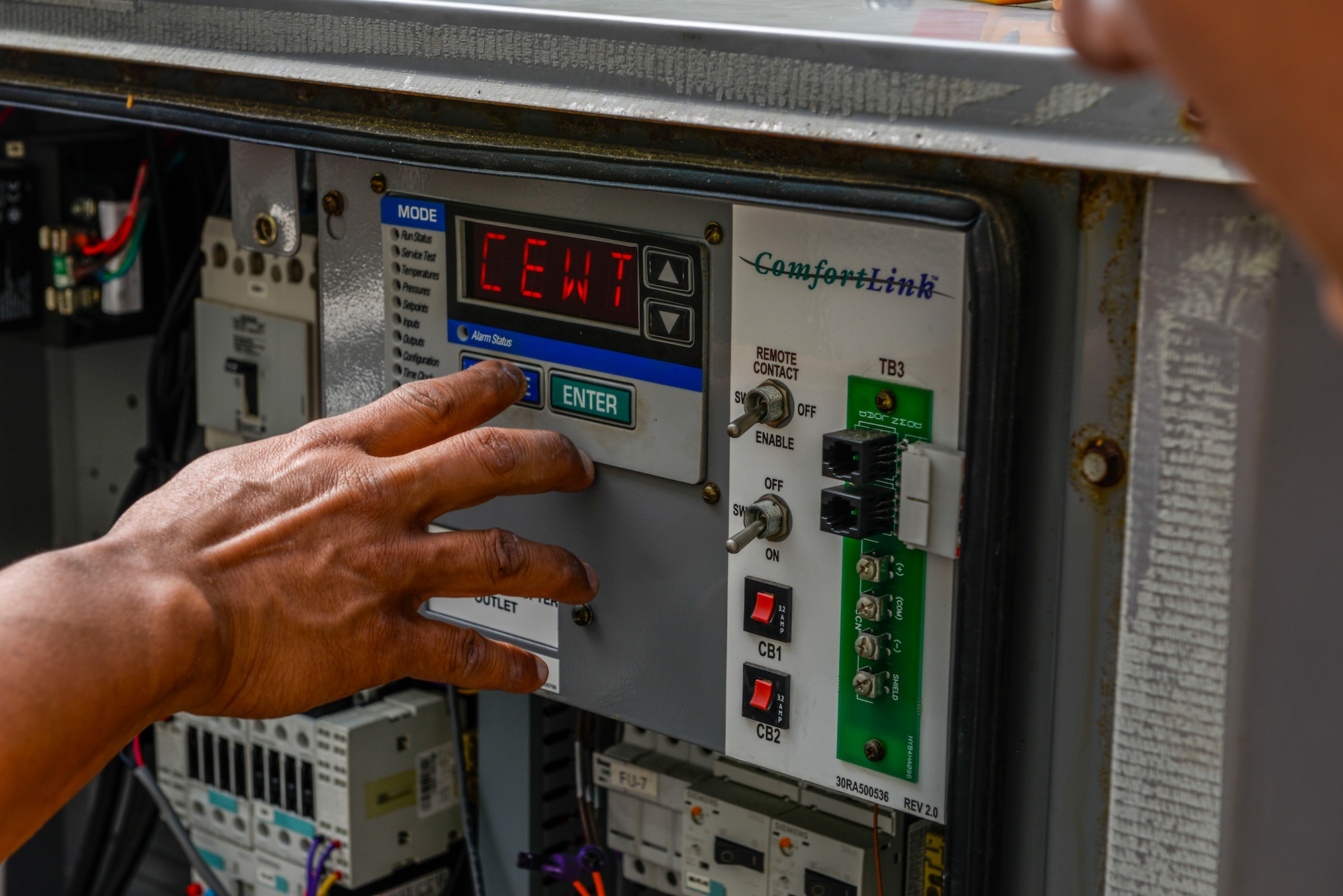Mr. Aladin Nono, 18th Civil Engineer Squadron heating, ventilation and air conditioning equipment maintainer, checks for mechanical and electrical failures in a condensor fan system April 28, 2016, at Kadena Air Base, Japan. The HVAC shop responds to an average of 300 calls in the summertime and in the off season, work orders are down to about 100. (U.S. Air Force photo by Senior Airman Stephen G. Eigel)