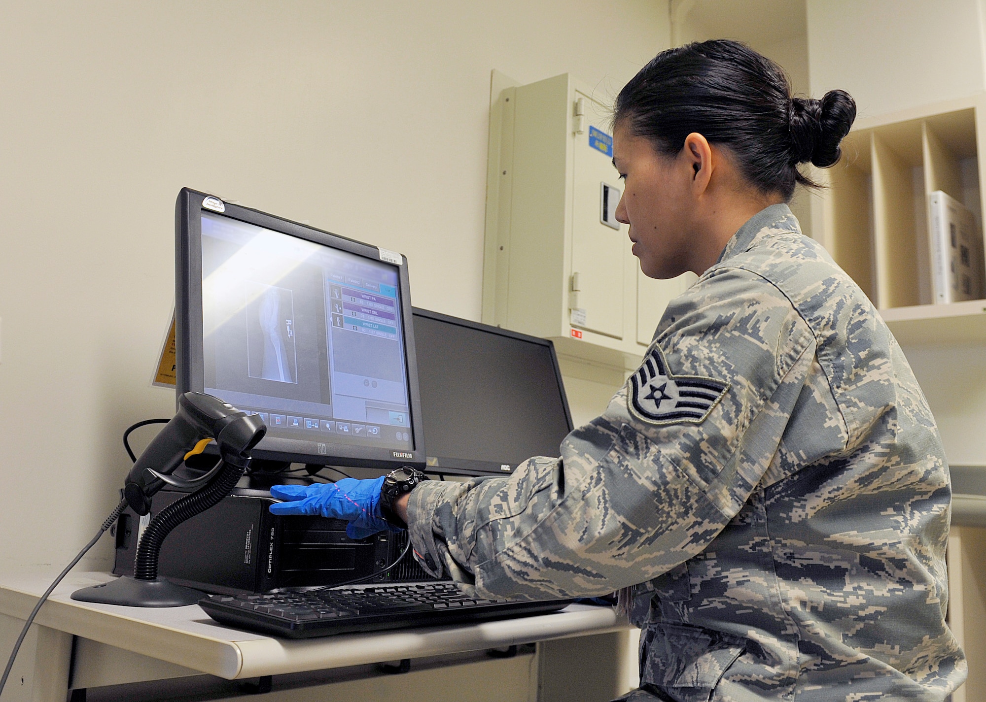 U.S. Air Force Staff Sgt. Mariecrist Shuty, 18th Medical Support Squadron radiology technologist, examines an X-ray, April 29, 2016, at Kadena Air Base, Japan. The 18th Medical Support Squadron operates across the Kadena squadrons, enhancing the health and wellness of Kadena’s warfighters and their family members through services that include information systems, laboratory, logistics, medical readiness, nutritional medicine, pharmacy, resource management, and patient administration. (U.S. Air Force photo by Naoto Anazawa)