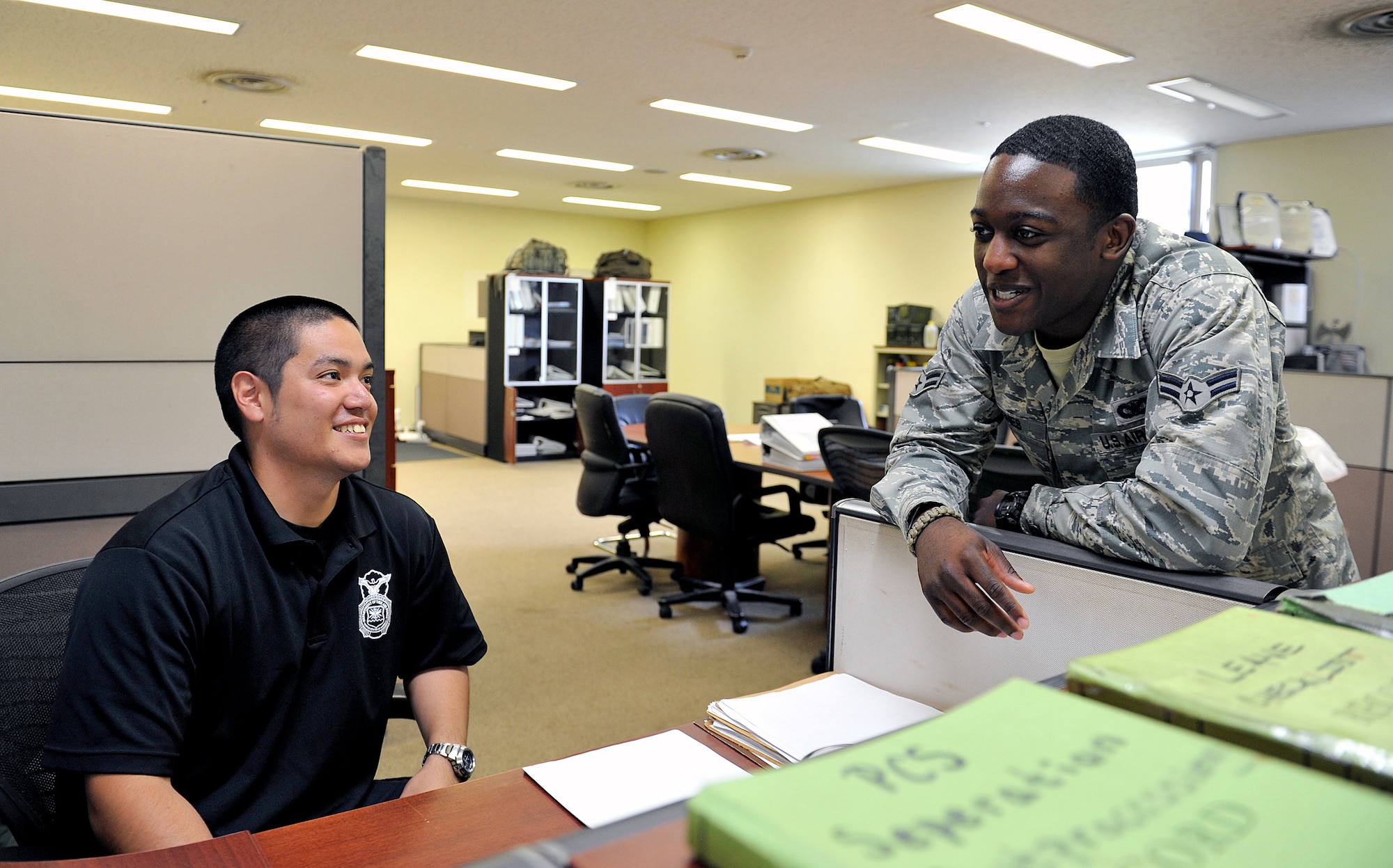 Yoshikazu Isa, 18th Security Forces Squadron master labor contractor training instructor, interacts with U.S. Air Force Airman 1st Class Trent Jones, 18th SFS unit scheduler, May 3, 2016, at Kadena Air Base, Japan. According to Isa, the members of the 18th SFS welcomed him as family and he has strong bonds with them. (U.S. Air Force photo by Naoto Anazawa)

