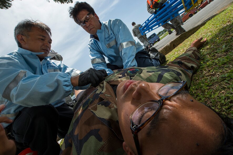 Kadena emergency responders treat a simulated victim for gunshot wounds during an active shooter exercise May 4, 2016, at Kadena Air Base, Japan. The exercise, which came as a surprise to participants and responders, gave Wing Inspection Team members an understanding of Kadena’s current capabilities and gave them a chance to prepare participants for potential real-world scenarios. (U.S. Air Force photo by Staff Sgt. Maeson L. Elleman)
