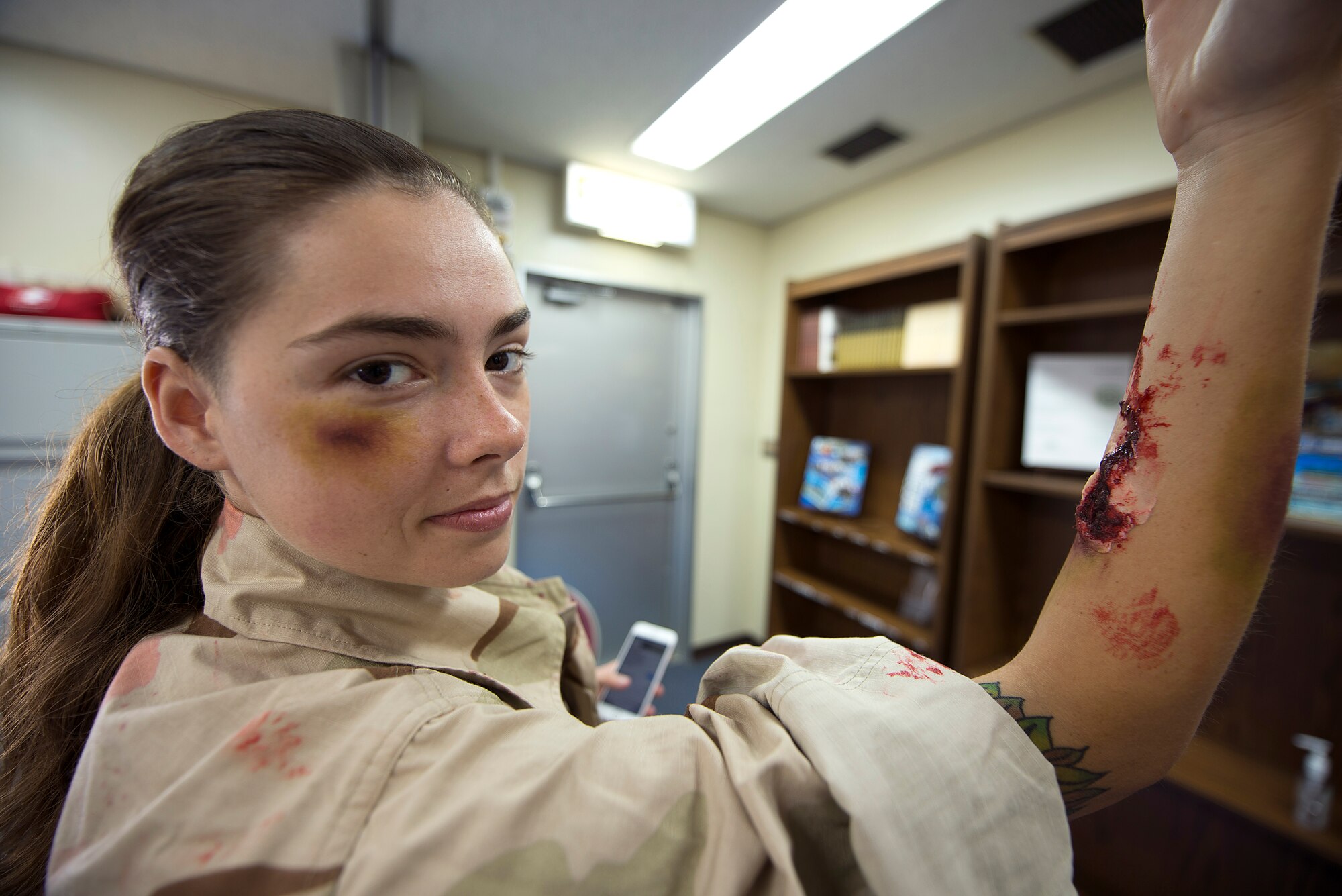 U.S. Air Force Airman Gabrielle Bully, 18th Operations Support Squadron aircrew flight equipment apprentice, displays her moulage makeup just before an active shooter exercise May 4, 2016, at Kadena Air Base, Japan. Wing Inspection Team members frequently use simulated victims like Bully to provide realistic training to emergency responders and better prepare them for potential real-world scenarios. (U.S. Air Force photo by Staff Sgt. Maeson L. Elleman)