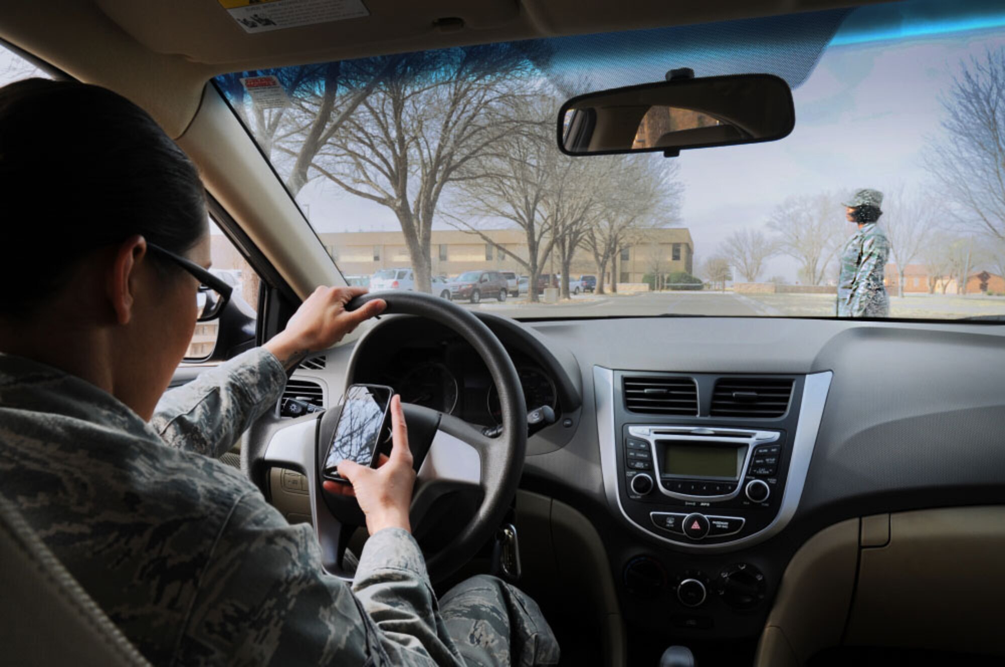 An Air Commando practices unsafe driving habits at Cannon Air Force Base, N.M. Human Factors & Ergonomics Society found that on average, texting while driving takes place by 800,000 drivers at any given time across the country; this act has been found to slow brake reaction speeds by up to 18 percent. (U.S. Air Force photo/Staff Sgt. Alexx Pons)  