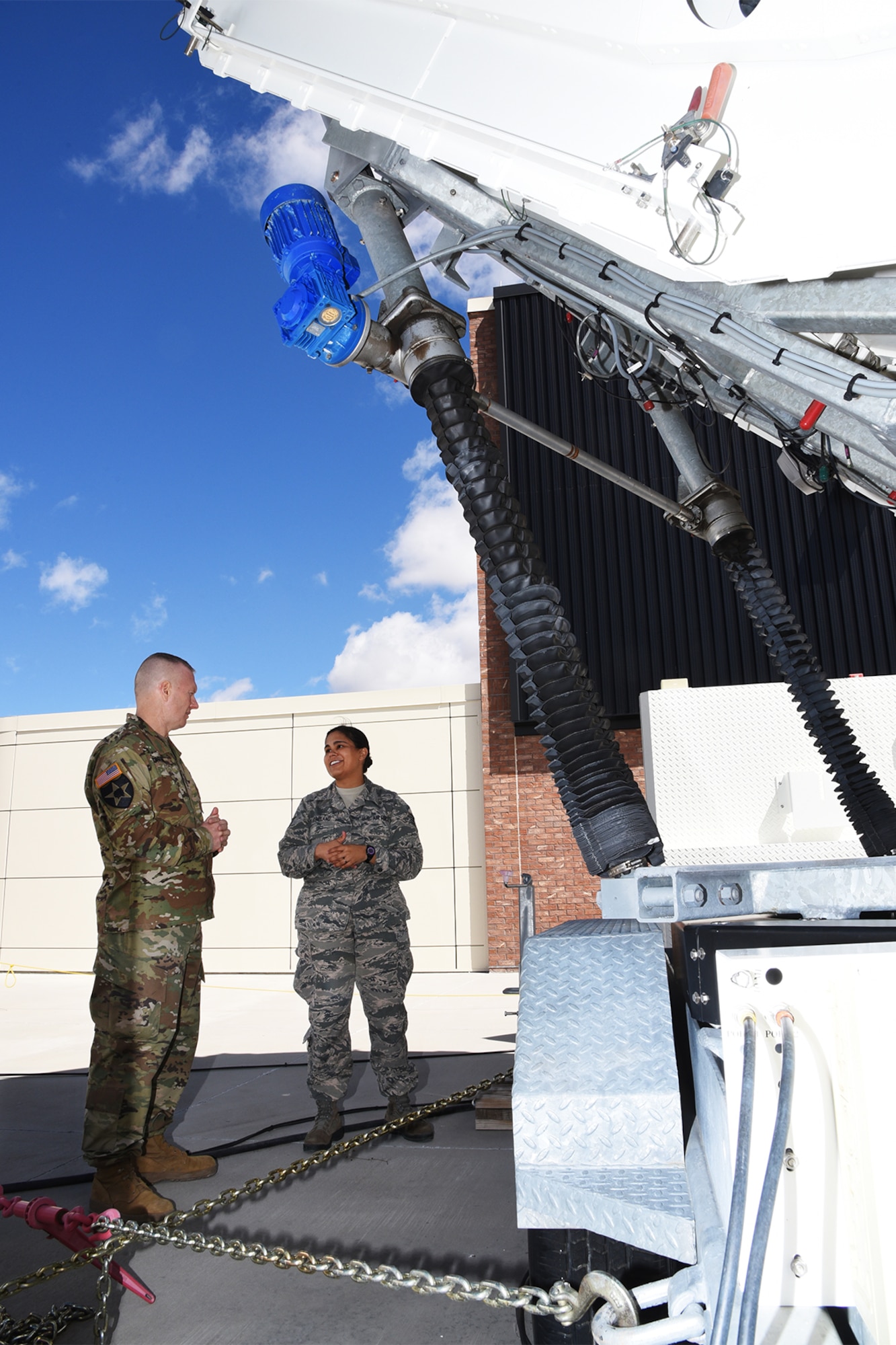 PETERSON AIR FORCE BASE, Colo. – Command Sgt. Maj. John Troxell, Senior Enlisted Advisor to the Chairman of the Joint Chiefs of Staff, speaks with Staff Sgt. Salina McFarland, 16th Space Control Squadron Defensive Space Control Communications maintainer, at Peterson Air Force Base April 27, 2016. McFarland explains that as an antenna maintainer, she is responsible for completing the preventative maintenance inspections, configuration changes, and any necessary repairs on the antennas while deployed, and that the biggest obstacle faced downrange is the dirt and the humidity.  (U.S. Air Force photo by Airman 1st Class Dennis Hoffman)