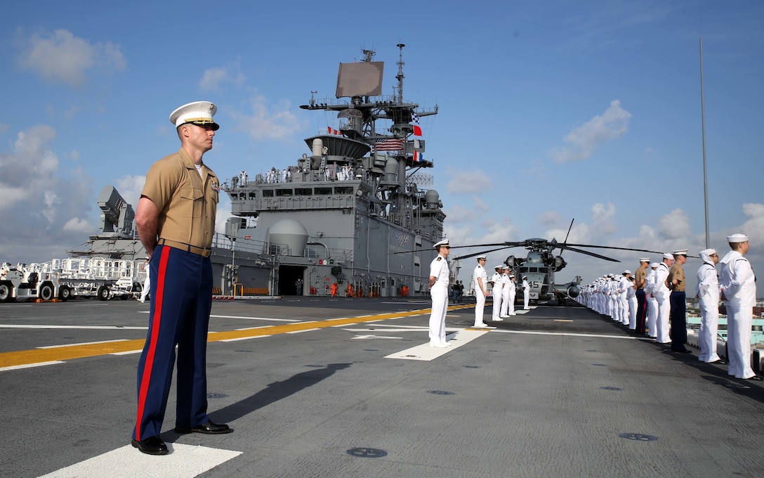 Marines and sailors aboard the USS Bataan extend out across the flight deck while manning the rails as the ship anchors in Port Everglades, Fort Lauderdale, Florida, May 2, 2016. Fleet Week, which takes place in Fort Lauderdale, from May 2-8, will give the community of South Florida the opportunity to interact with the Marines and sailors of the ship as well as see some of the capabilities and equipment the Marine Corps-Navy team employs. 