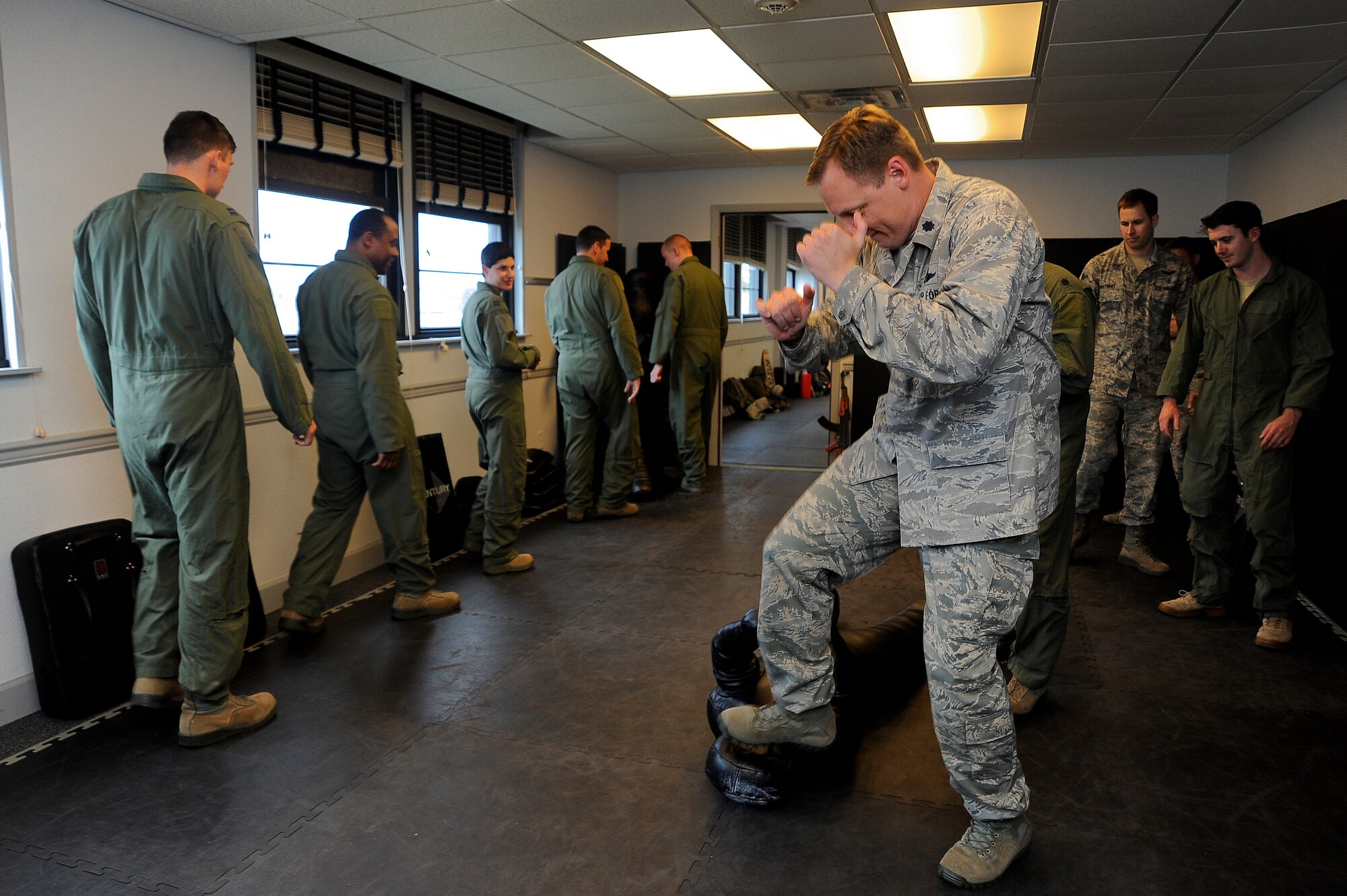 Aircrew members from various squadrons practice defense moves during a combat survival training refresher course at MacDill Air Force Base, Fla., April 27, 2016. Airmen learned how to defend themselves in a number of situations to include when the enemy has a weapon. (U.S. Air Force photo by Airman 1st Class Mariette Adams)