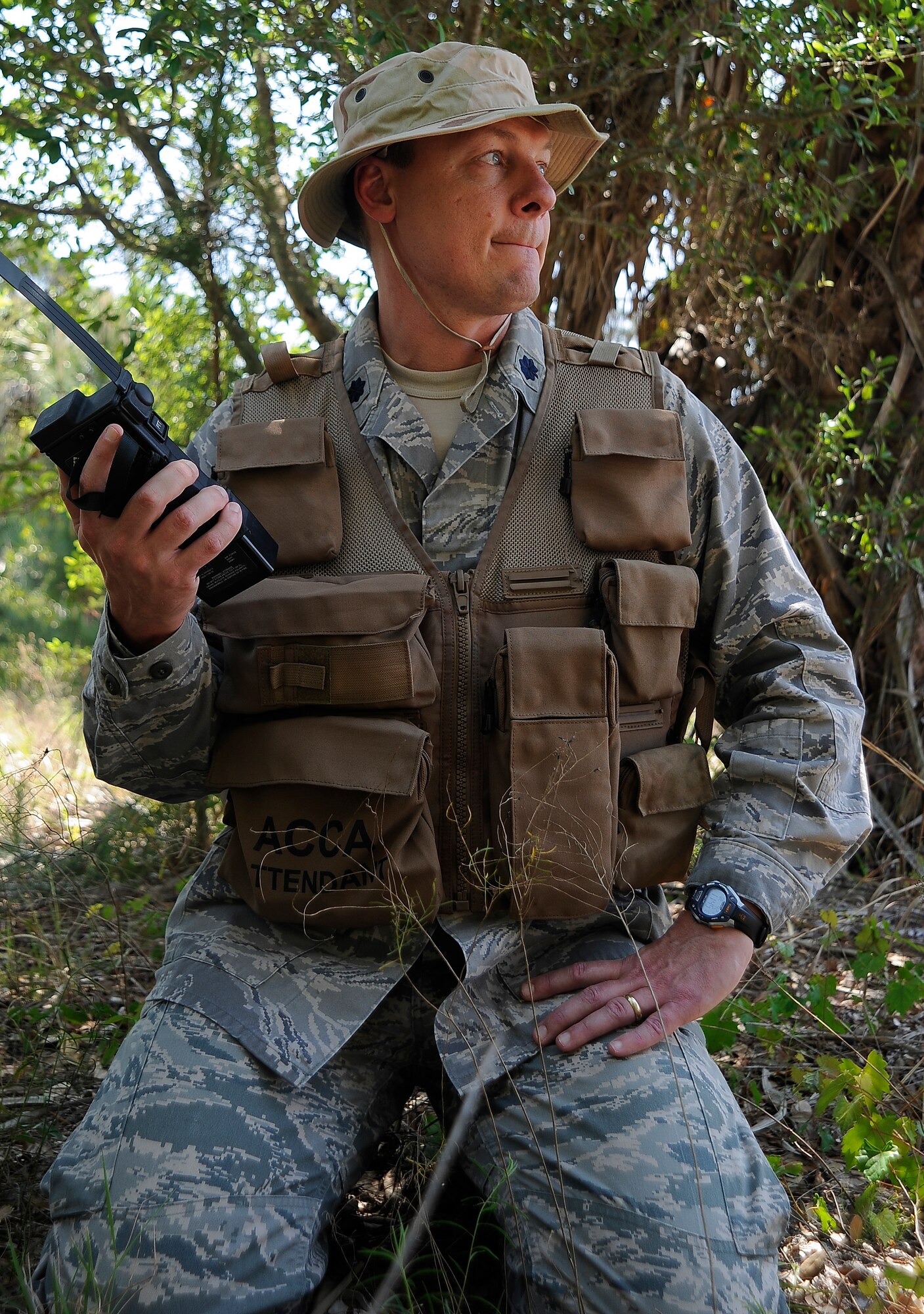 Lt. Col. Randy Naylor, an aircrew member, waits for a response on the radio as he hides from oppositional forces during a combat survival training refresher course at MacDill Air Force Base, Fla., April 27, 2016. Radio signal is an essential part of rescue because it creates communication between the rescuers and those in destress. (U.S. Air Force photo by Airman 1st Class Mariette Adams)