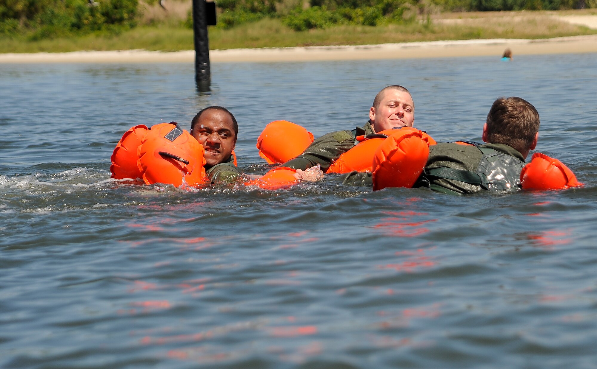 Aircrew members from various squadrons practice swimming techniques during water survival training at MacDill Air Force Base, Fla., April 29, 2016. Students were required to demonstrate various swimming exercises during the training. (U.S. Air Force photo by Airman 1st Class Mariette Adams)