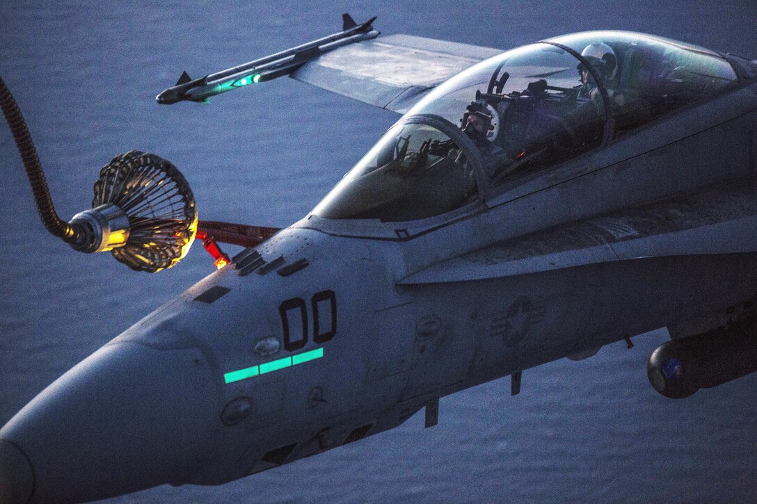 Marines refuel in the air over Iwakuni, Japan, April 28, 2016, practicing during the day and night to prepare for any scenario. The Marines are assigned to Marine Aerial Refueler Transport Squadron 152 and Marine All-Weather Fighter Attack Squadron 242. Marine Corps photo by Cpl. Nathan Wicks