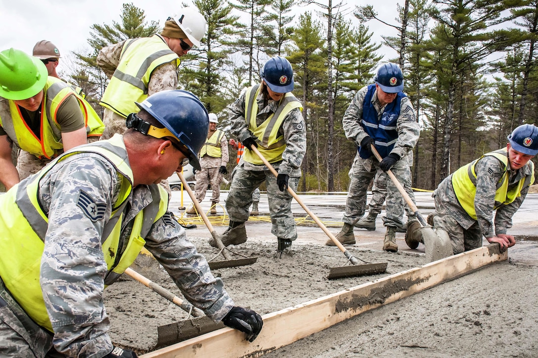 Airmen and Marine Reservists build a porch for a new dining facility at Camp Hinds in Raymond, Maine, May 3, 2016. Air National Guard photo by Airman Tiffany Clark