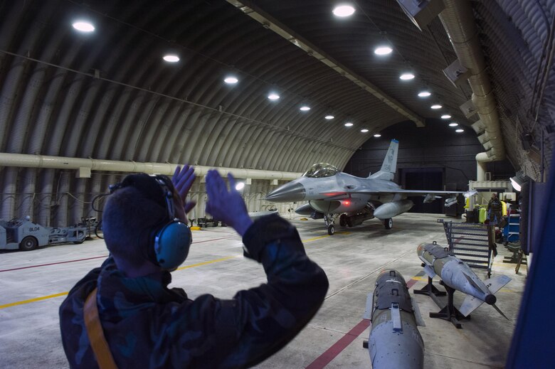 Staff Sgt. Corey Spencer, 80th Aircraft Maintenance Unit crew chief, marshals an F-16 Fighting Falcon from the 35th Fighter Squadron Beverly Midnight 16-3 at Kunsan Air Base, Republic of Korea, May 4, 2016. The exercise tested Airmen on their ability to survive and operate while under the stress of simulated wartime activities all while ensuring aircraft generate. (U.S. Air Force photo by Staff Sgt. Nick Wilson/Released)