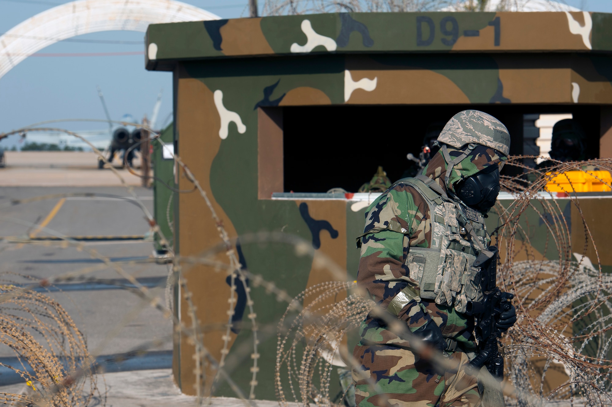 Staff Sgt. Mario Huerta, 8th Security Forces Squadron response force leader, walks through an entry control point during Exercise Beverly Midnight 16-3 at Kunsan Air Base, Republic of Korea, May 4, 2016. The exercise put Airmen to the test by incorporating building evacuation operations, ground, chemical, biological, radiological, nuclear and high-yield explosive attacks, unexploded ordinance detection, and self-aid and buddy care techniques into scenarios throughout the week. (U.S. Air Force photo by Staff Sgt. Nick Wilson/Released)