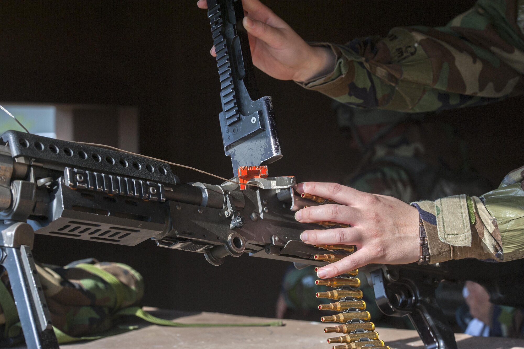 A response force Airman puts ammo into an M240 machine gun at an entry control point during Exercise Beverly Midnight 16-3 at Kunsan Air Base, Republic of Korea, May 4, 2016. During the exercise, the Wolf Pack persevered through 24-hour operations and demonstrated their ability to perform under the stress of reacting to simulated wartime conditions. (U.S. Air Force photo by Staff Sgt. Nick Wilson/Released)