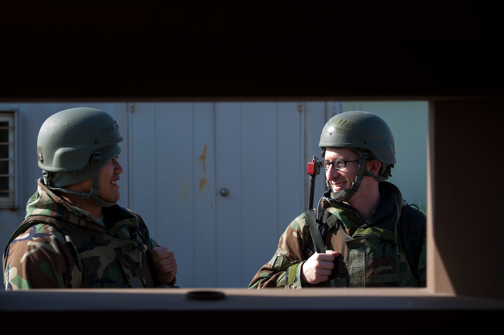 Senior Airman Jesse Oeur, 8th Security Forces Squadron response force member, and Staff Sgt. Scott Trembley, 8th SFS response force leader, share a laugh as they discuss mission tactics during Exercise Beverly Midnight 16-3 at Kunsan Air Base, Republic of Korea, May 4, 2016. The exercise focused on readiness--testing Kunsan’s wartime procedures by realistically looking at the ability to defend the base, execute operations and sustain follow-on forces. (U.S. Air Force photo by Staff Sgt. Nick Wilson/Released)