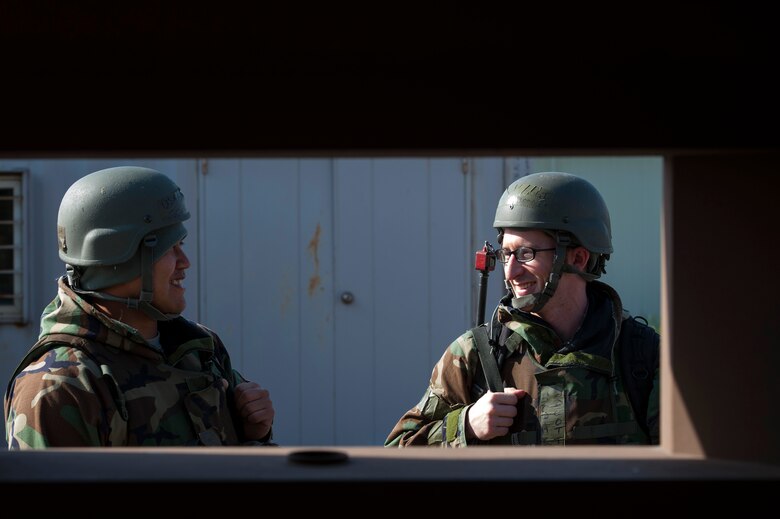 Senior Airman Jesse Oeur, 8th Security Forces Squadron response force member, and Staff Sgt. Scott Trembley, 8th SFS response force leader, share a laugh as they discuss mission tactics during Exercise Beverly Midnight 16-3 at Kunsan Air Base, Republic of Korea, May 4, 2016. The exercise focused on readiness--testing Kunsan’s wartime procedures by realistically looking at the ability to defend the base, execute operations and sustain follow-on forces. (U.S. Air Force photo by Staff Sgt. Nick Wilson/Released)