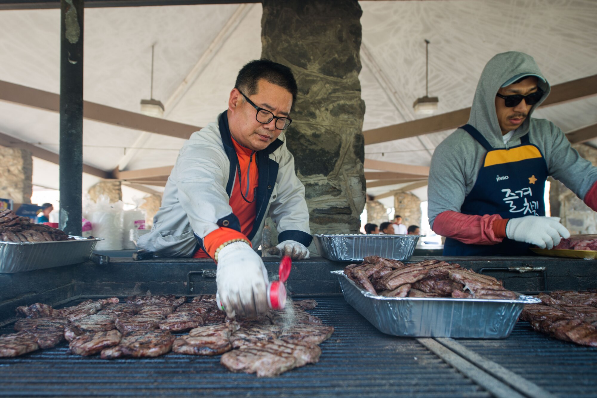 Team Osan members grill steaks during a Korean Labor Day lunch May 4, 2016, at Osan Air Base, Republic of Korea.  Osan highlights Korean Labor Day to celebrate the host-nation civilians who support the base daily.(U.S. Air Force photo by Senior Airman Dillian Bamman/Released)