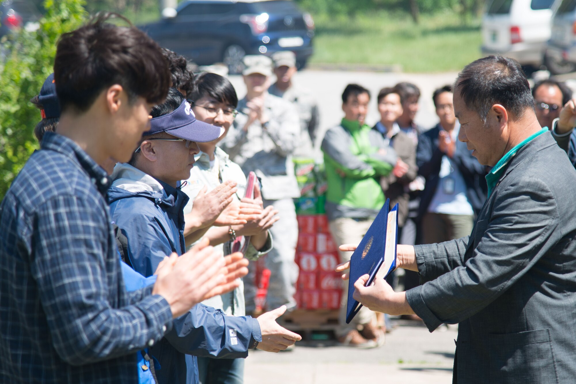 Team Osan Korean civilians receive certificates of appreciation during a Korean Labor Day pavilion lunch May 4, 2016, at Osan Air Base, Republic of Korea. Osan highlights Korean Labor Day to celebrate the host-nation civilians who support the base daily. (U.S. Air Force photo by Senior Airman Dillian Bamman/Released)