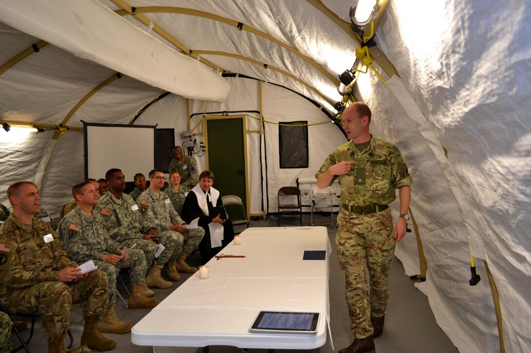 The Reverend Giles Allen (CF), of the Royal Army Chaplain’s Department (RAChD), prepares the Eucharist worship service held during exercise Anakonda Response 2016 at Papa Air Base, Hungary, May 1, 2016. The exercise was organized by the 7th Mission Support Command, an Army Reserve unit based in Kaiserslautern, Germany. (U.S. Air National Guard photo by Tech. Sgt. Andria Allmond)