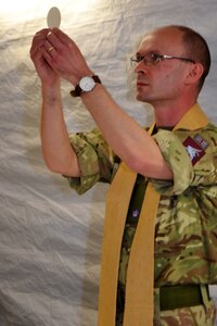 The Reverend Giles Allen (CF), of the Royal Army Chaplain’s Department (RAChD), prepares the Eucharist worship service held during exercise Anakonda Response 2016 at Papa Air Base, Hungary, May 1, 2016. The exercise was organized by the 7th Mission Support Command, an Army Reserve unit based in Kaiserslautern, Germany. (U.S. Air National Guard photo by Tech. Sgt. Andria Allmond)