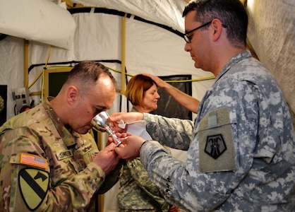 The Reverend Giles Allen (CF), of the Royal Army Chaplain’s Department (RAChD), prepares the Eucharist worship service held during exercise Anakonda Response 2016 at Papa Air Base, Hungary, May 1, 2016. The exercise was organized by the 7th Mission Support Command, an Army Reserve unit based in Kaiserslautern, Germany. (U.S. Air National Guard photo by Tech. Sgt. Andria Allmond)